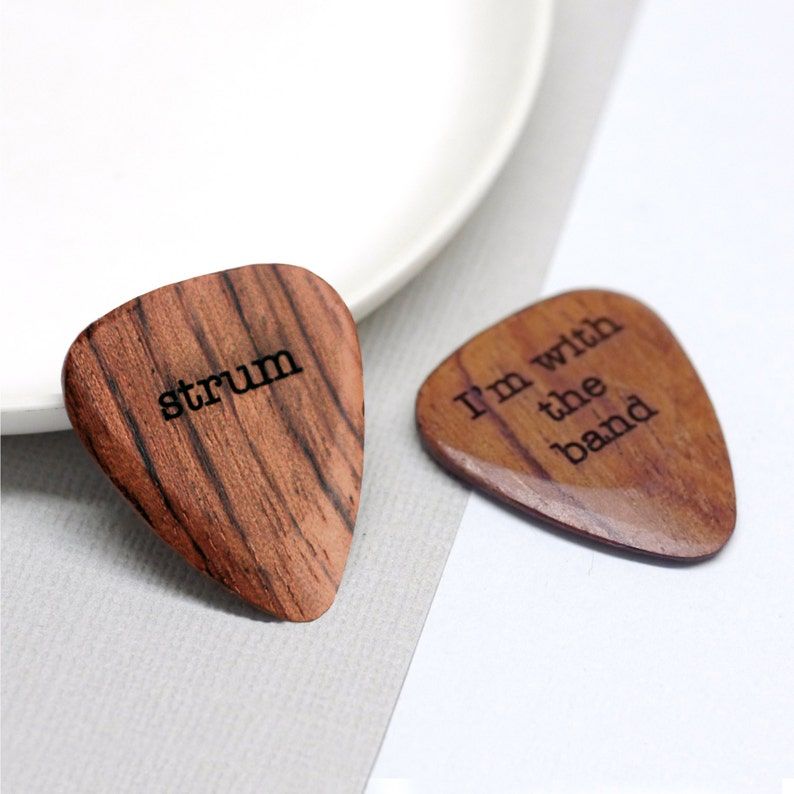 A simple wooden guitar plectrum, customised with your choice of words.